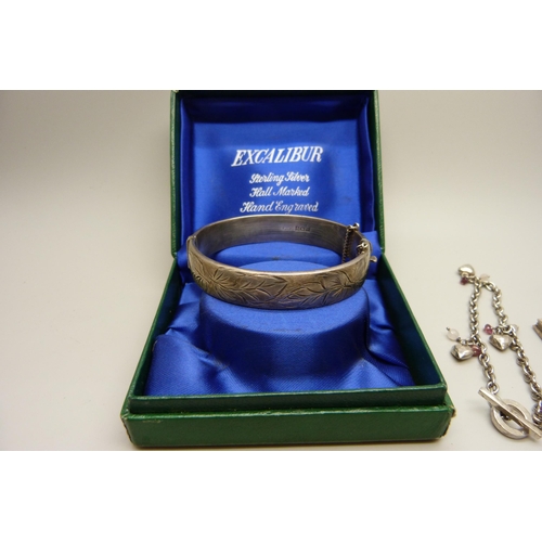 879 - A vintage silver bangle in original box and two silver charm bracelets, 51g