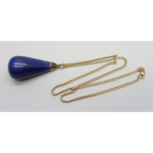 924 - A large yellow metal mounted lapis lazuli pendant on a 9ct gold chain, chain 2g and 40cm