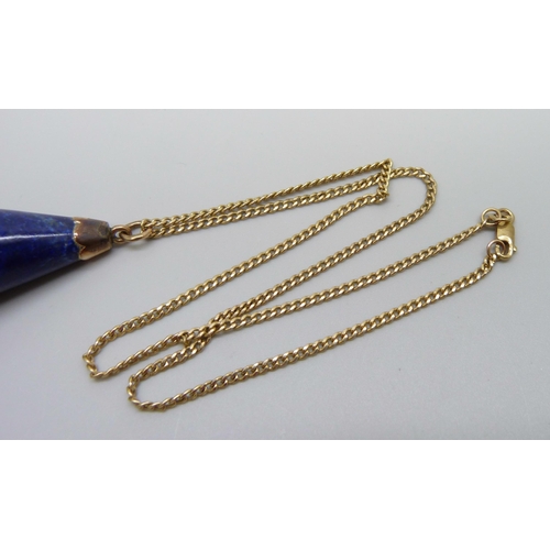 924 - A large yellow metal mounted lapis lazuli pendant on a 9ct gold chain, chain 2g and 40cm