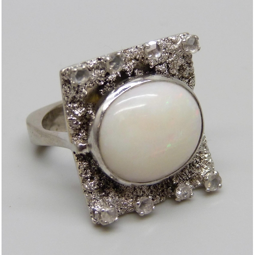 927 - A 9ct white gold Brutalist style ring set with eight old cut diamonds and a large opal, Birmingham 1... 