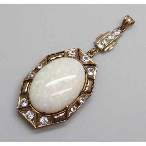 931 - An Art Deco yellow metal drop pendant set with white stones and a large opal, opal 16mm x 24mm, 8g