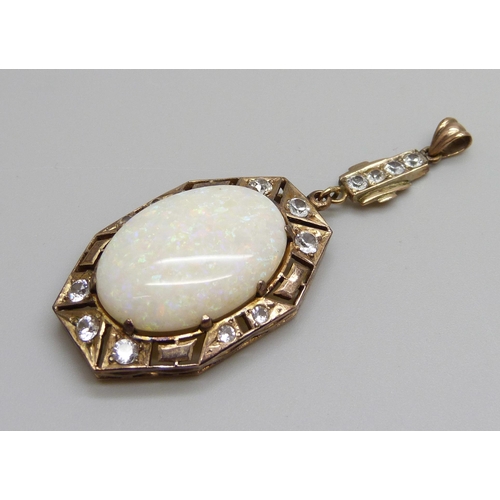 931 - An Art Deco yellow metal drop pendant set with white stones and a large opal, opal 16mm x 24mm, 8g