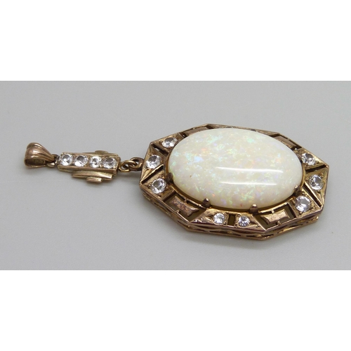 931 - An Art Deco yellow metal drop pendant set with white stones and a large opal, opal 16mm x 24mm, 8g