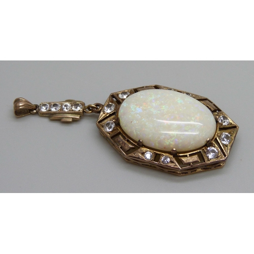 931 - An Art Deco yellow metal drop pendant set with white stones and a large opal, opal 16mm x 24mm, 8g