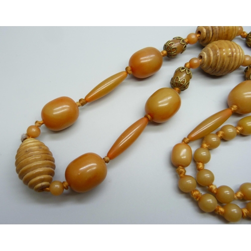 932 - An amber coloured and carved bead necklace