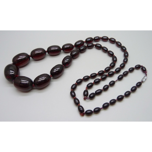 933 - A long string of sherry amber coloured beads, 103g