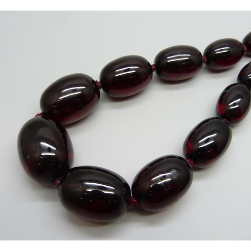 933 - A long string of sherry amber coloured beads, 103g