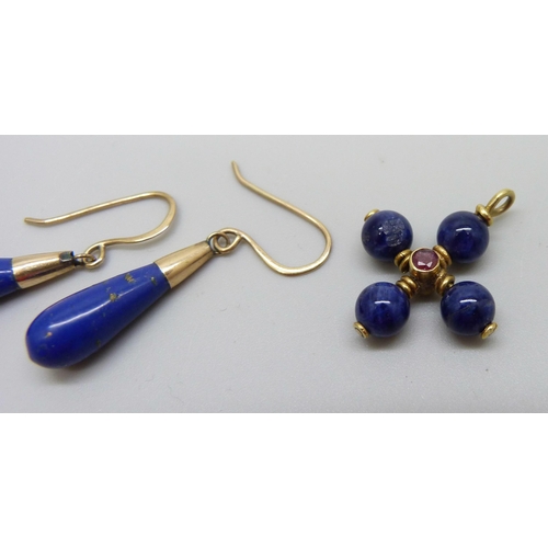 943 - A pair of lapis lazuli earrings on yellow metal hooks and a yellow metal lapis and ruby pendant