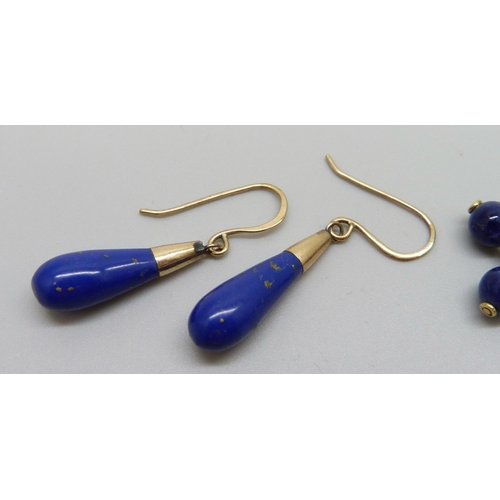 943 - A pair of lapis lazuli earrings on yellow metal hooks and a yellow metal lapis and ruby pendant