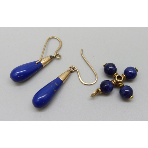 943 - A pair of lapis lazuli earrings on yellow metal hooks and a yellow metal lapis and ruby pendant