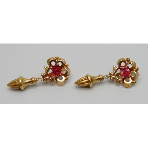 950 - A pair of yellow metal drop earrings set with red stones, with continental control marks, possibly G... 