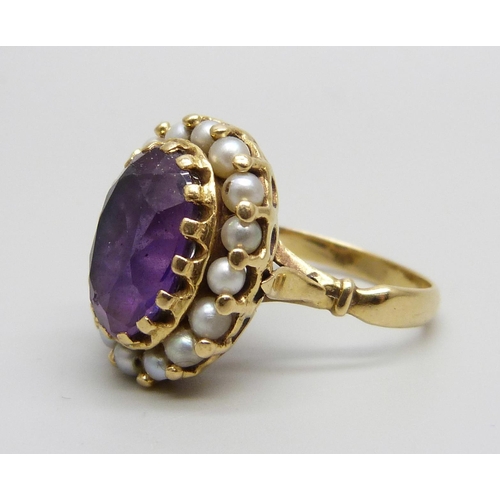 955 - An 18ct gold ring set with an amethyst and seed pearls, stamped 750, 7.7g, N