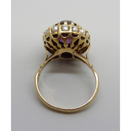 955 - An 18ct gold ring set with an amethyst and seed pearls, stamped 750, 7.7g, N