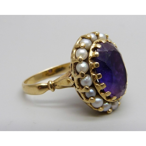 955 - An 18ct gold ring set with an amethyst and seed pearls, stamped 750, 7.7g, N