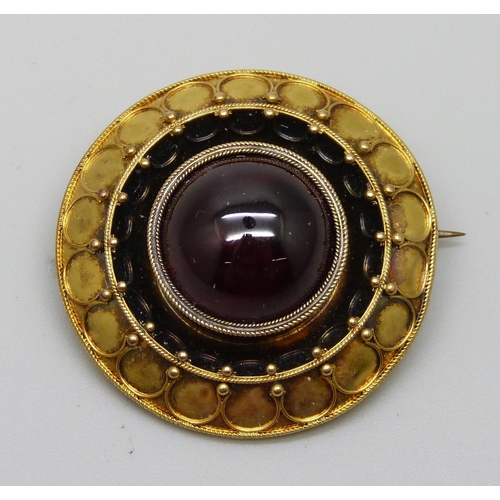 976 - A Victorian yellow metal brooch set with a cabochon garnet, 8g, 30mm