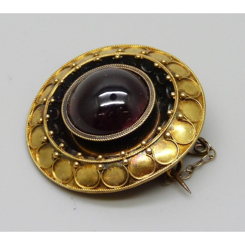 976 - A Victorian yellow metal brooch set with a cabochon garnet, 8g, 30mm