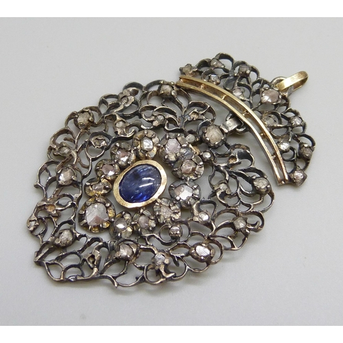 979 - A Georgian white and yellow metal pendant, set with rose cut diamonds and a Ceylon cabochon sapphire... 