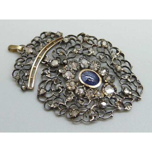 979 - A Georgian white and yellow metal pendant, set with rose cut diamonds and a Ceylon cabochon sapphire... 