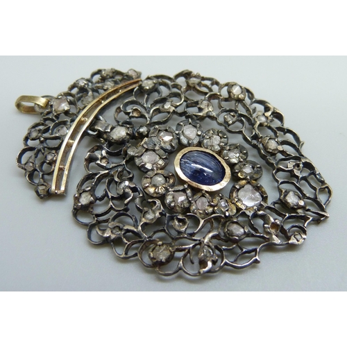 979 - A Georgian white and yellow metal pendant, set with rose cut diamonds and a Ceylon cabochon sapphire... 