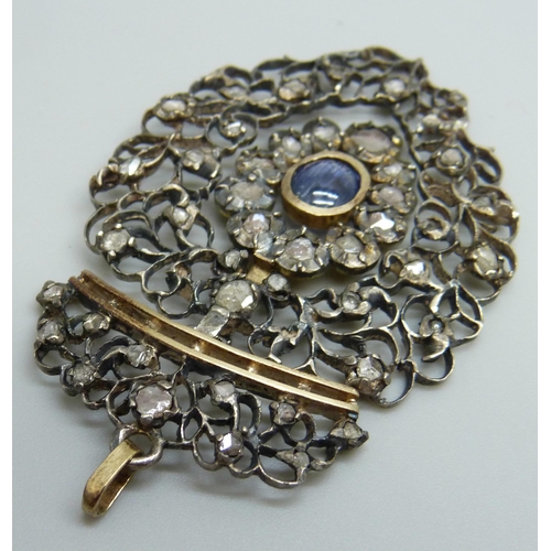 979 - A Georgian white and yellow metal pendant, set with rose cut diamonds and a Ceylon cabochon sapphire... 