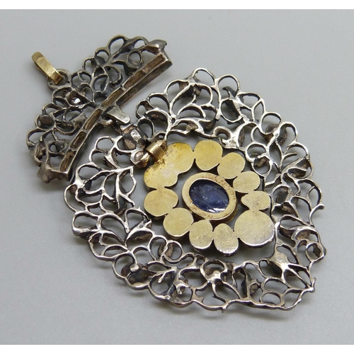 979 - A Georgian white and yellow metal pendant, set with rose cut diamonds and a Ceylon cabochon sapphire... 