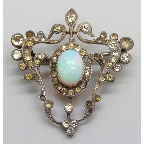 982 - A silver Art Nouveau brooch set with paste stones and a central opal, some stones lacking