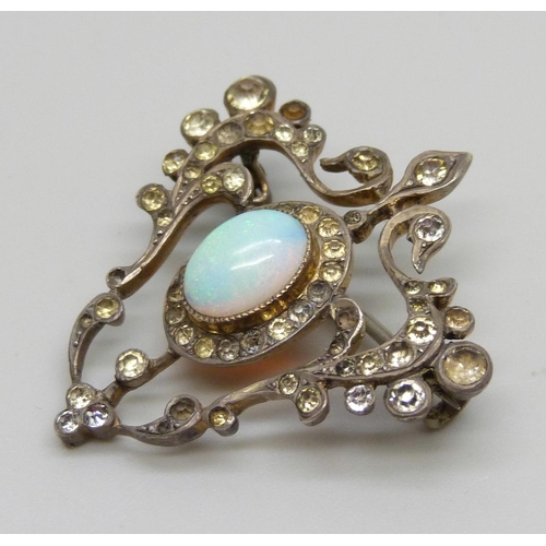 982 - A silver Art Nouveau brooch set with paste stones and a central opal, some stones lacking