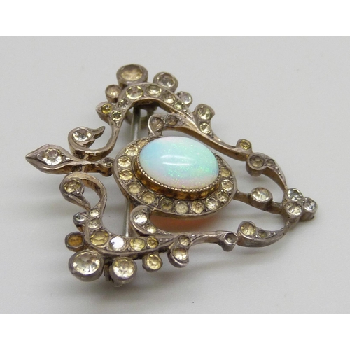 982 - A silver Art Nouveau brooch set with paste stones and a central opal, some stones lacking