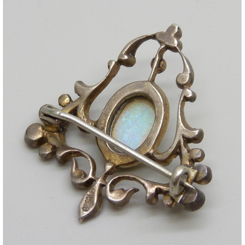 982 - A silver Art Nouveau brooch set with paste stones and a central opal, some stones lacking