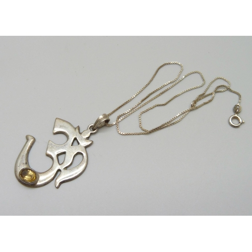 989 - An Arabic symbol silver pendant and chain