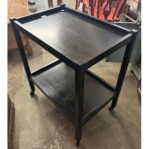 99 - A Danish ebonised teak two tier trolley