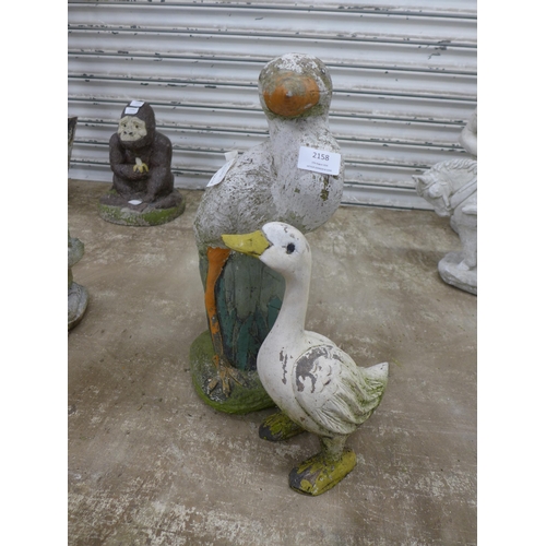 2158 - 2 duck garden ornaments including a duck on a log and one other