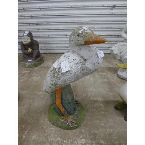 2158 - 2 duck garden ornaments including a duck on a log and one other