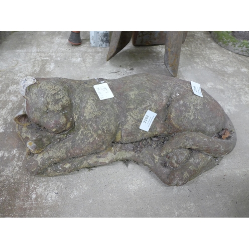 2162 - Concrete garden ornaments including a sleeping cat, a sleeping fox, a dog and a cast metal cat in a ... 