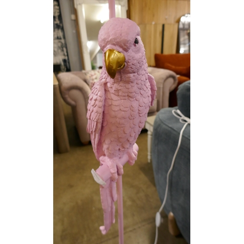 1336 - A pink floor standing parrot lamp