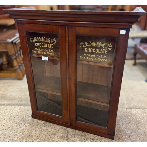 178 - A Victorian mahogany two door wall hanging display cabinet, bearing Cadburys Chocolate inscription t... 