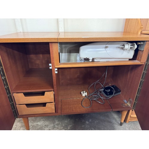 34 - A Singer 744 model teak sewing machine cabinet