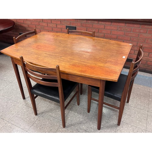 49 - A Danish teak extending dining table and four chairs