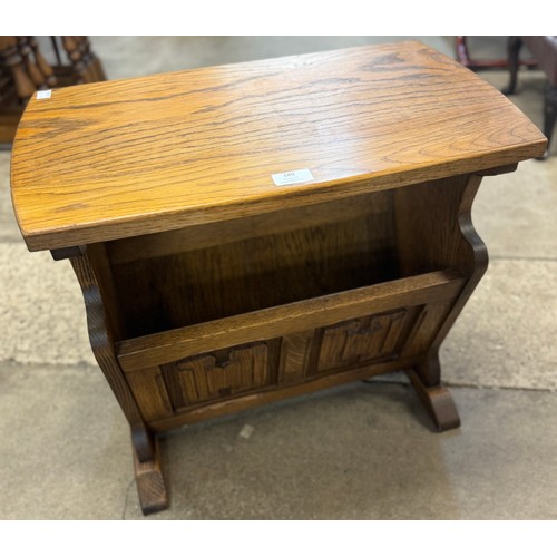 201 - A carved oak linenfold coffee table/magazine rack