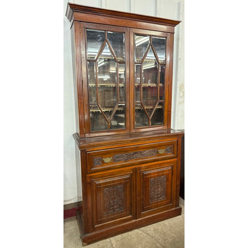 124 - A Victorian Aesthetic Movement carved walnut secretaire bookcase