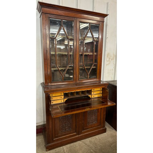 124 - A Victorian Aesthetic Movement carved walnut secretaire bookcase