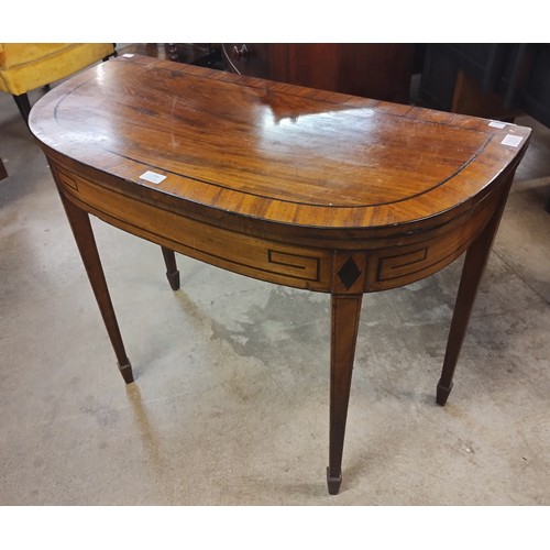 156 - A Regency mahogany demi-lune fold over games table