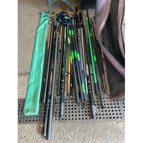 2102 - A quantity of fishing rods and poles with a fishing rod bag