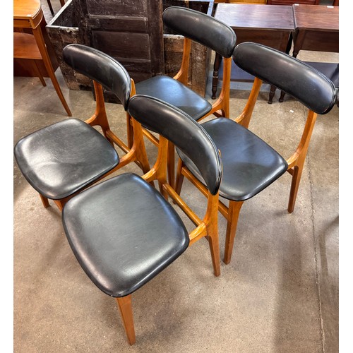 56 - A set of four teak and black vinyl chairs