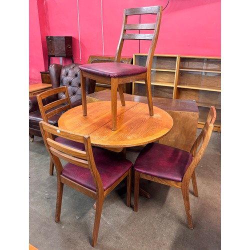 64 - A Nathan teak circular extending dining table and four chairs