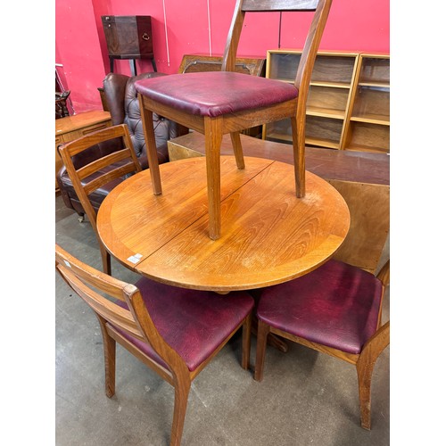 64 - A Nathan teak circular extending dining table and four chairs