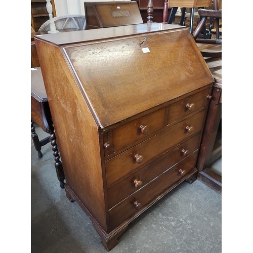 166 - A George III style oak bureau