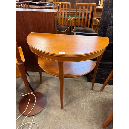 87 - A teak sewing box, demi lune hall table and a teak standard lamp