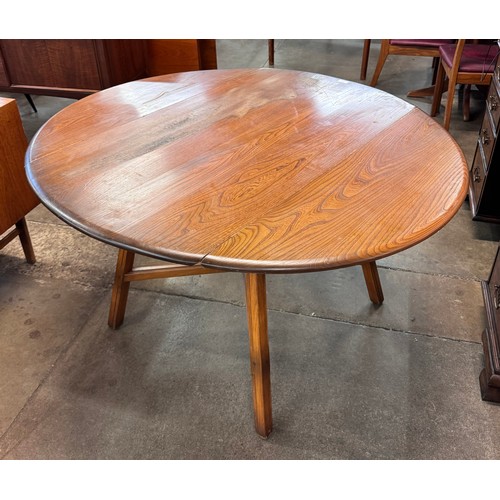 89 - An Ercol Golden Dawn elm drop leaf table