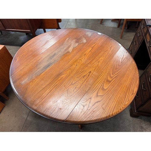 89 - An Ercol Golden Dawn elm drop leaf table